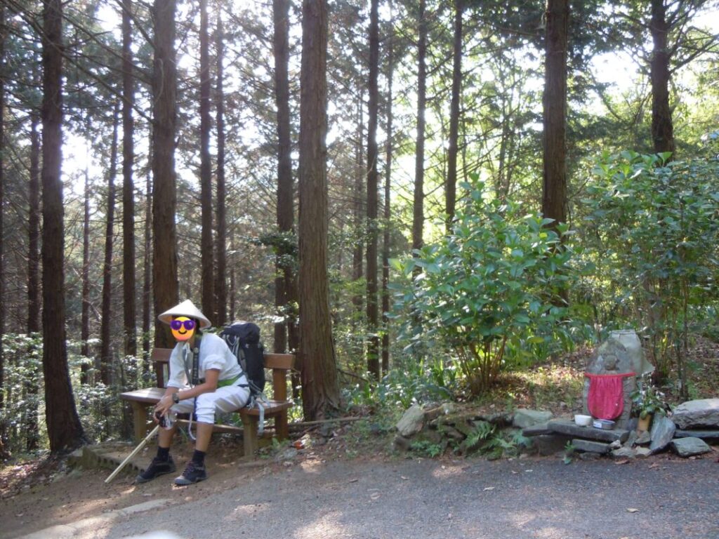 端山休憩所のベンチで休む私｜近くにはお地蔵様も佇む