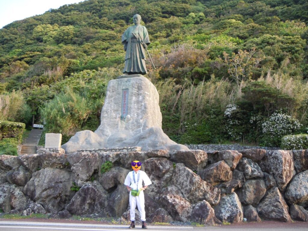 Me standing in front of the statue of Nakaoka Shintarō: dressed as a walking pilgrim